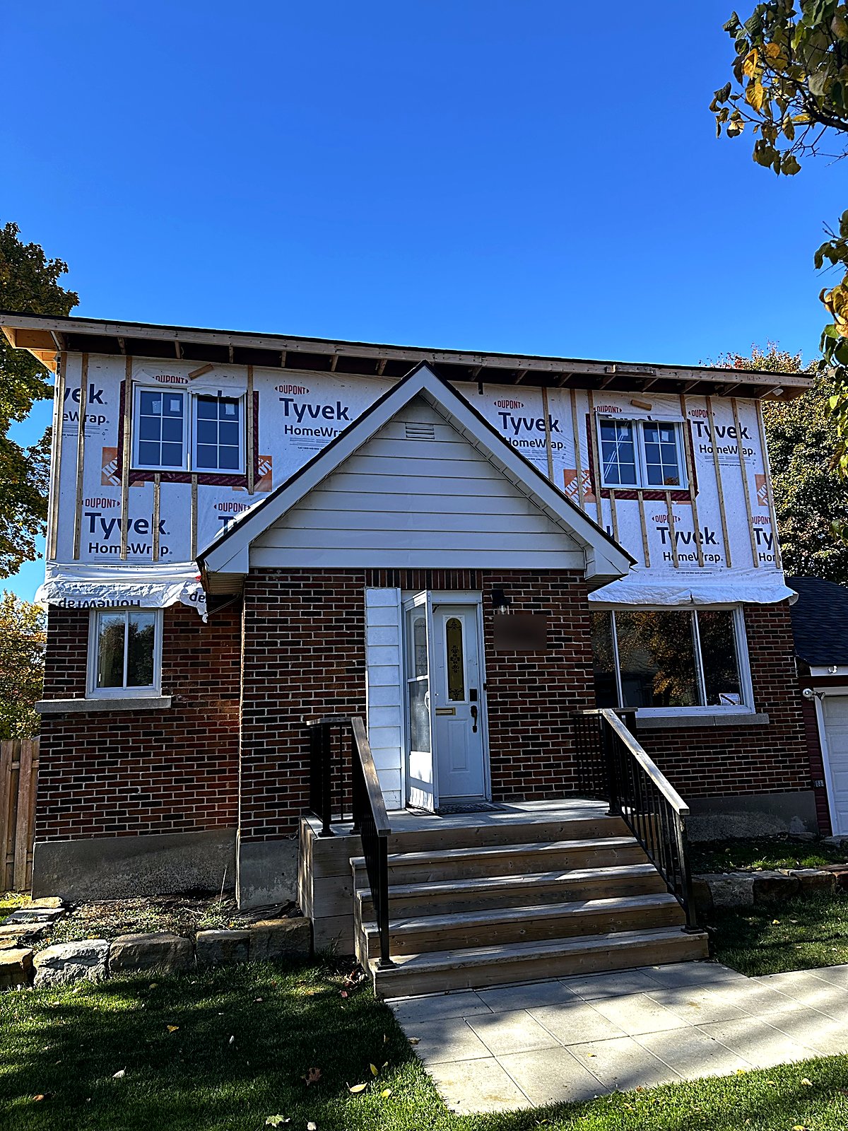 Second-storey addition framing, windows and house wrap by Buildrex Construction